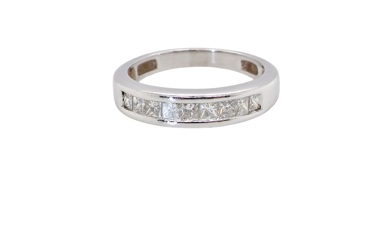 An elegant half-hoop eternity ring set with nine princess-cut white diamonds, each measuring approximately 2.5mm, with a total estimated diamond weight of 0.90 carats.