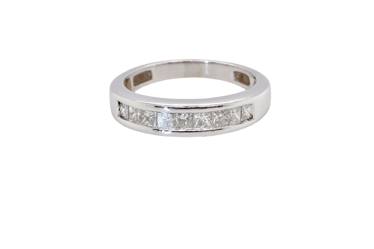 An elegant half-hoop eternity ring set with nine princess-cut white diamonds, each measuring approximately 2.5mm, with a total estimated diamond weight of 0.90 carats.
