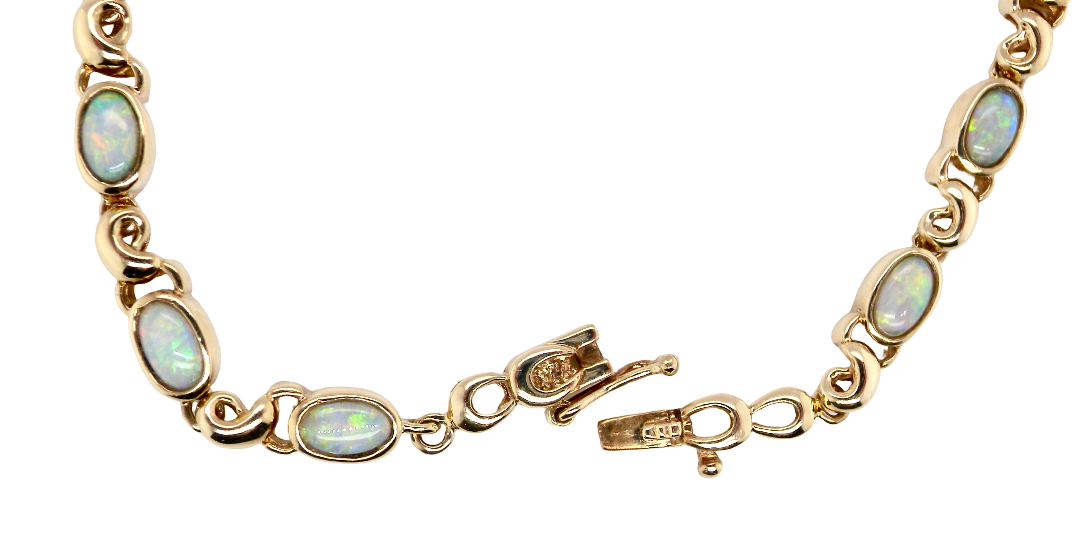 An elegant line bracelet set with fourteen oval opals, each measuring approximately 5 x 3 mm, displaying a lively play of colour.