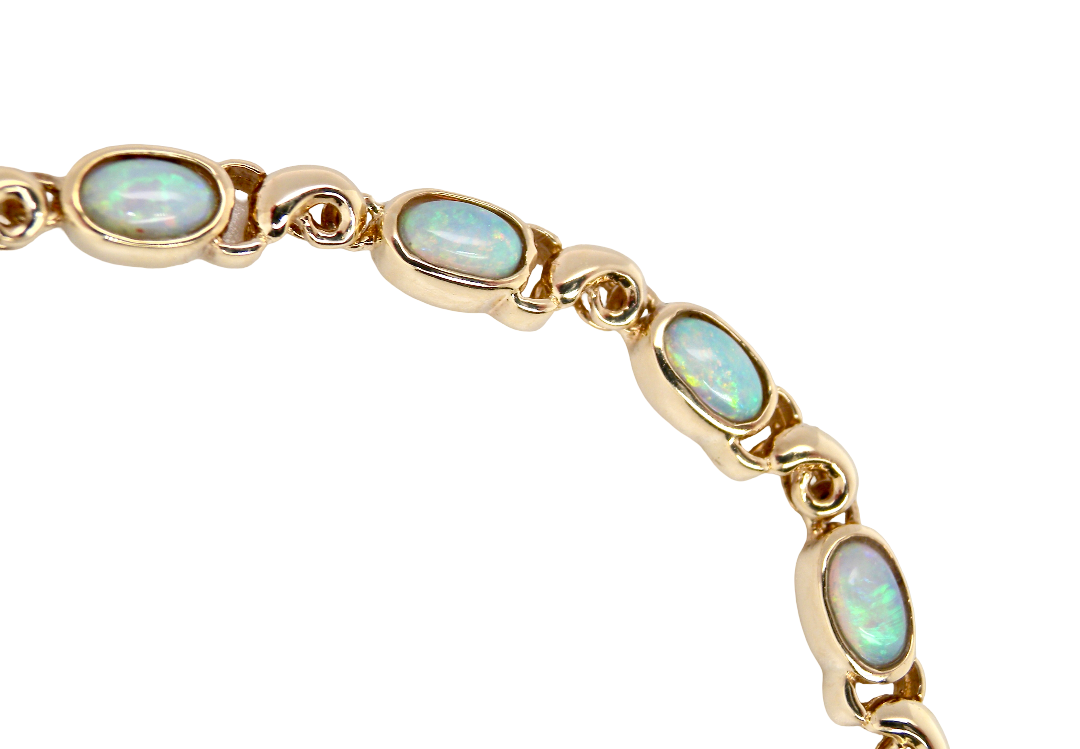 An elegant line bracelet set with fourteen oval opals, each measuring approximately 5 x 3 mm, displaying a good and lively play of colour.