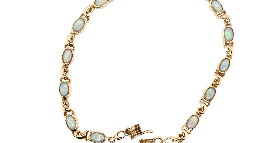 An elegant line bracelet set with fourteen oval opals, each measuring approximately 5 x 3 mm, displaying a pleasing and lively play of colour.