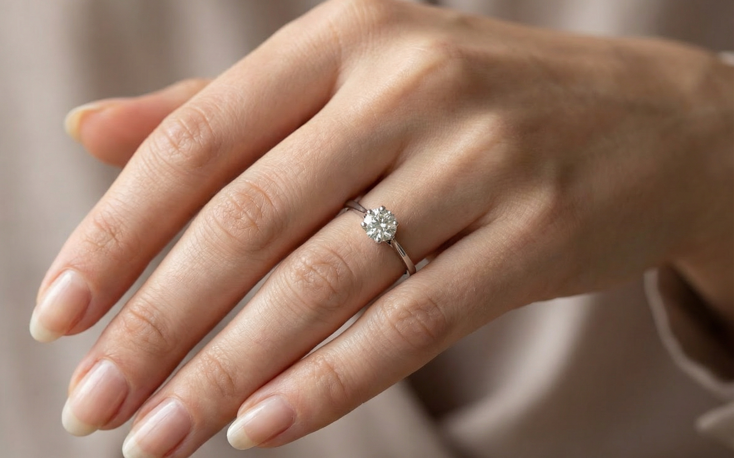 finger view An elegant single-stone solitaire ring set with an exceptional brilliant-cut white diamond, estimated at approximately 0.91 carats.