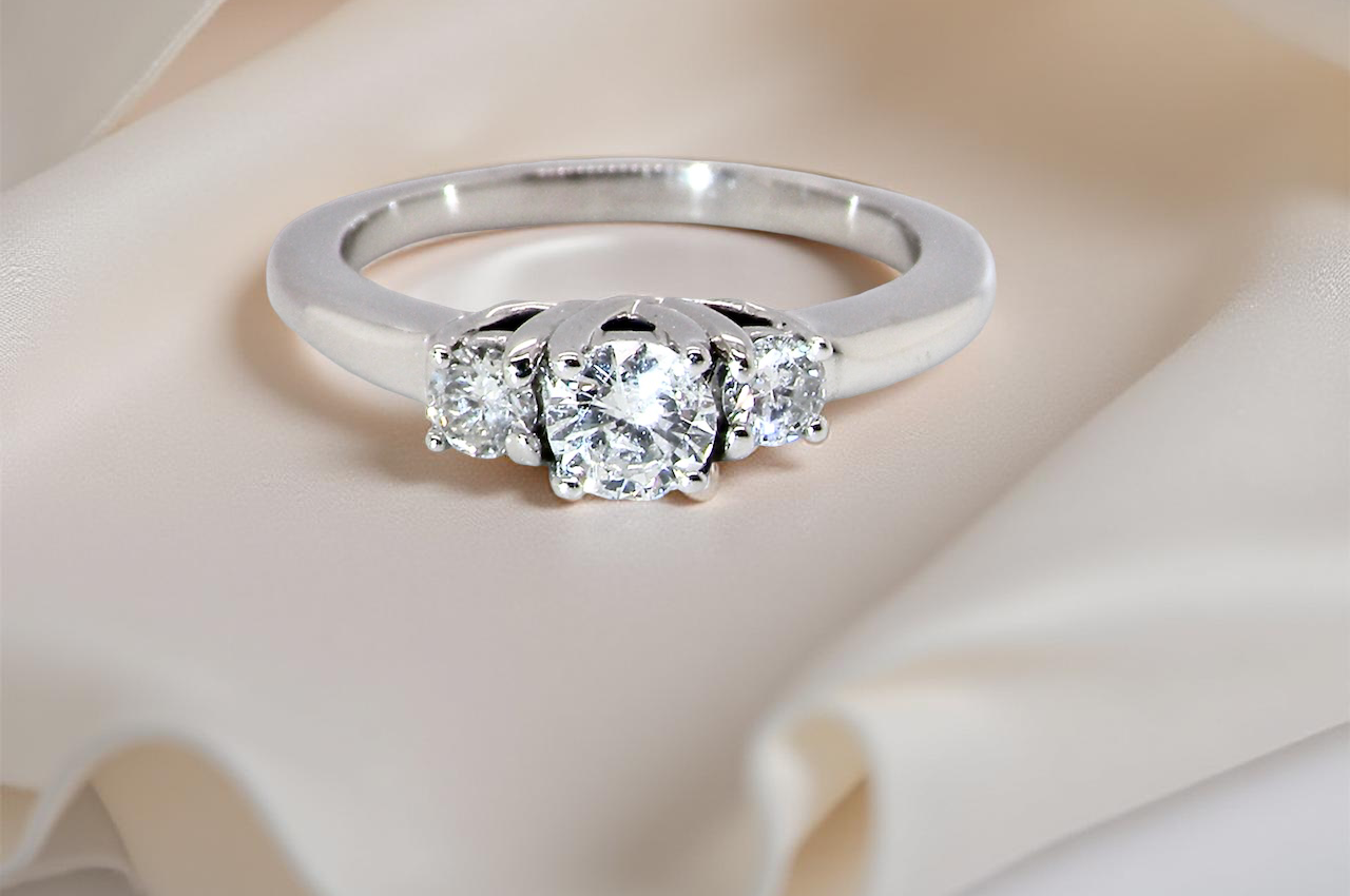 An elegant trilogy ring set with three brilliant-cut diamonds,