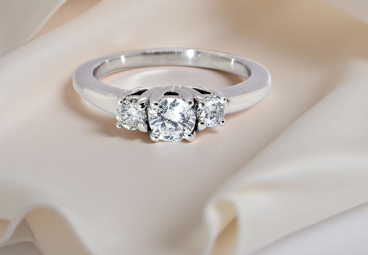 An elegant trilogy ring set with three brilliant-cut diamonds,
