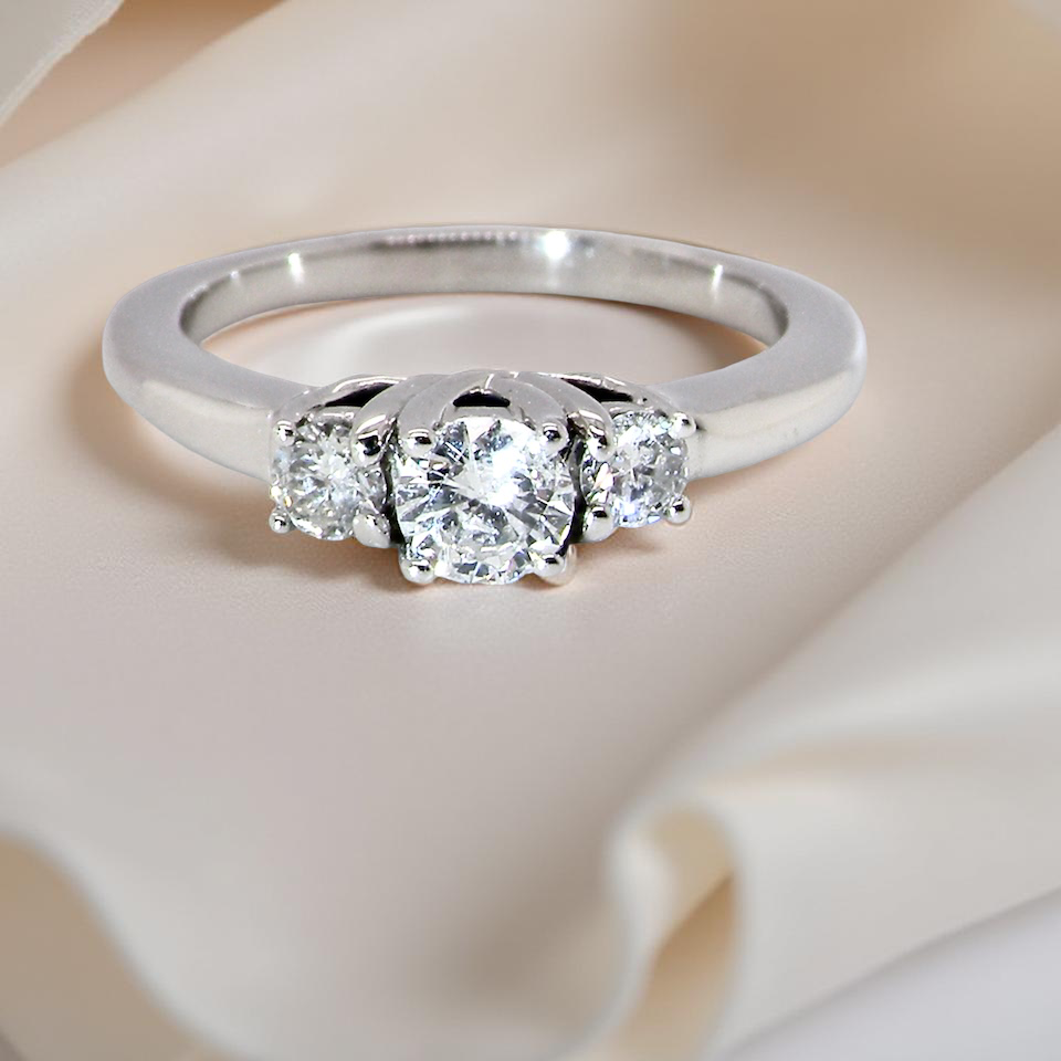 An elegant trilogy ring set with three brilliant-cut diamonds,