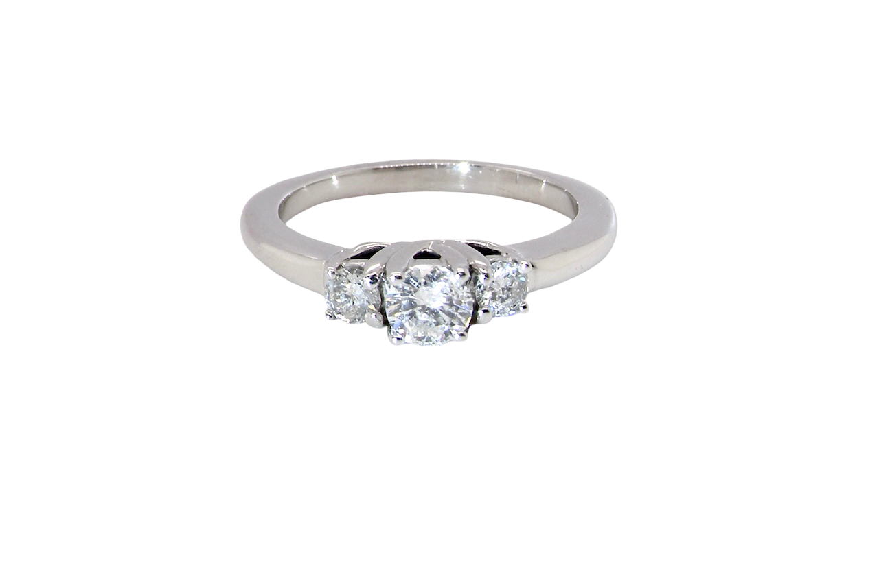 An elegant trilogy ring set with three brilliant-cut white diamonds,