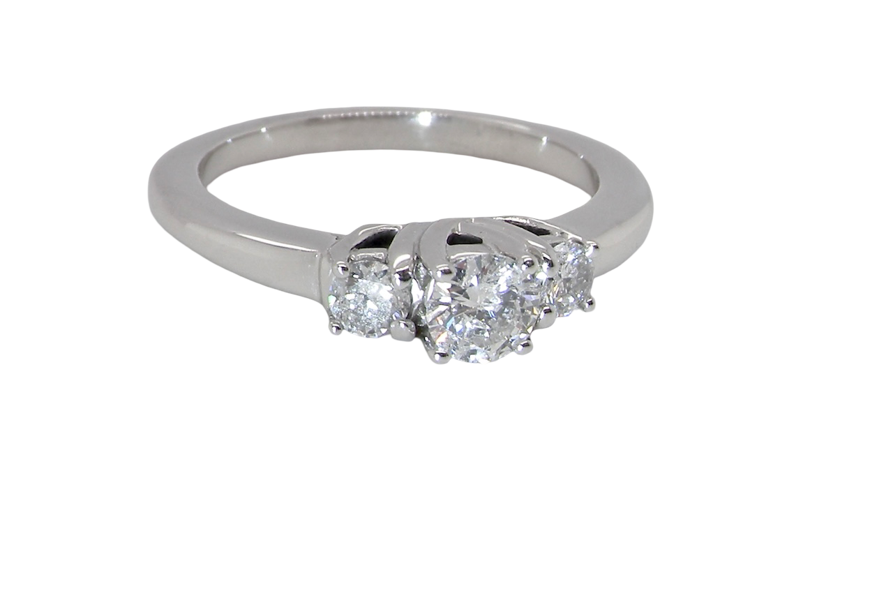 An elegant trilogy ring set with three brilliant-cut white diamonds, side