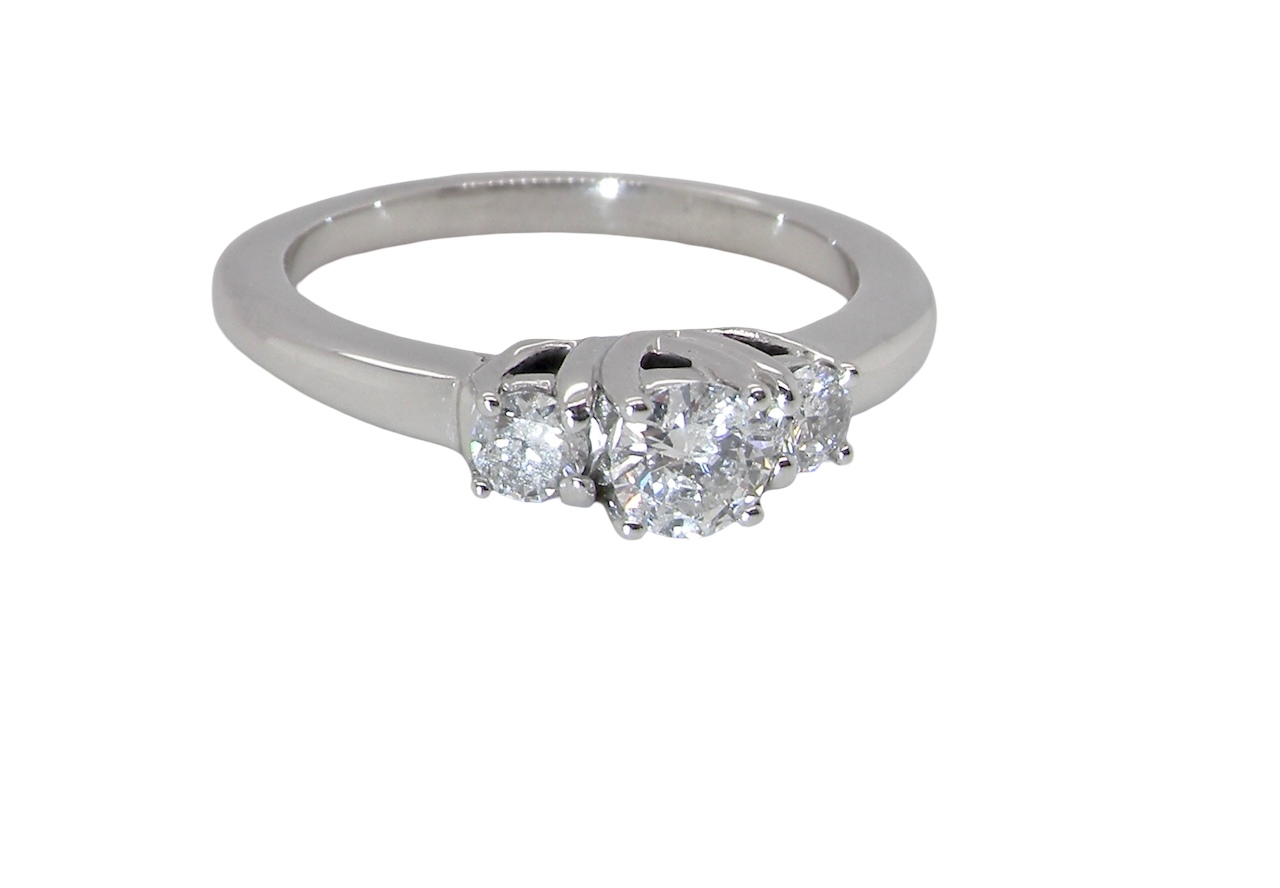 An elegant trilogy ring set with three brilliant-cut white diamonds, side