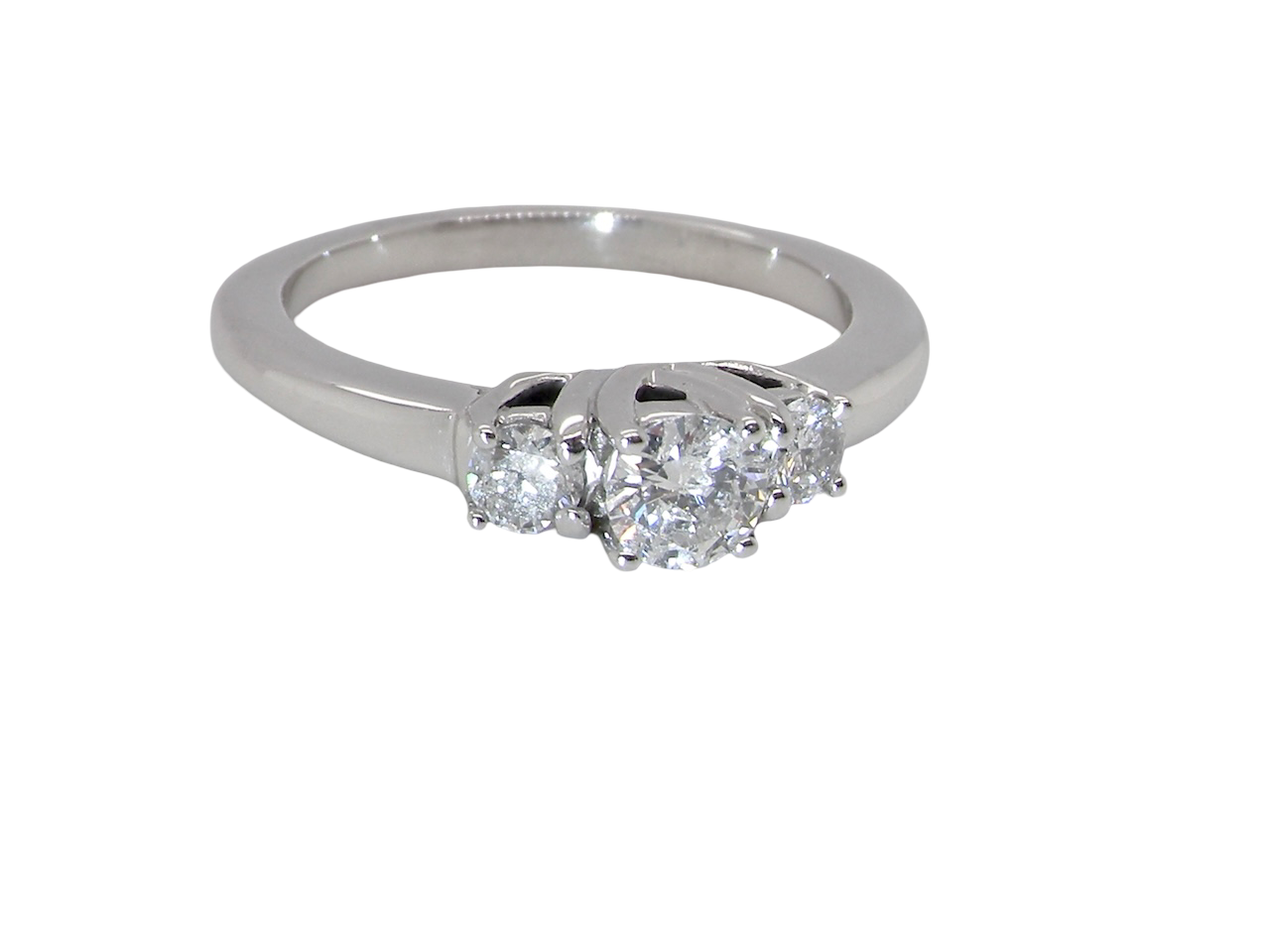 An elegant trilogy ring set with three brilliant-cut white diamonds, side