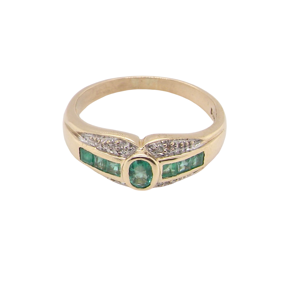 An emerald and diamond dress ring