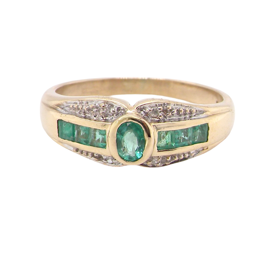 An emerald and diamond dress ring