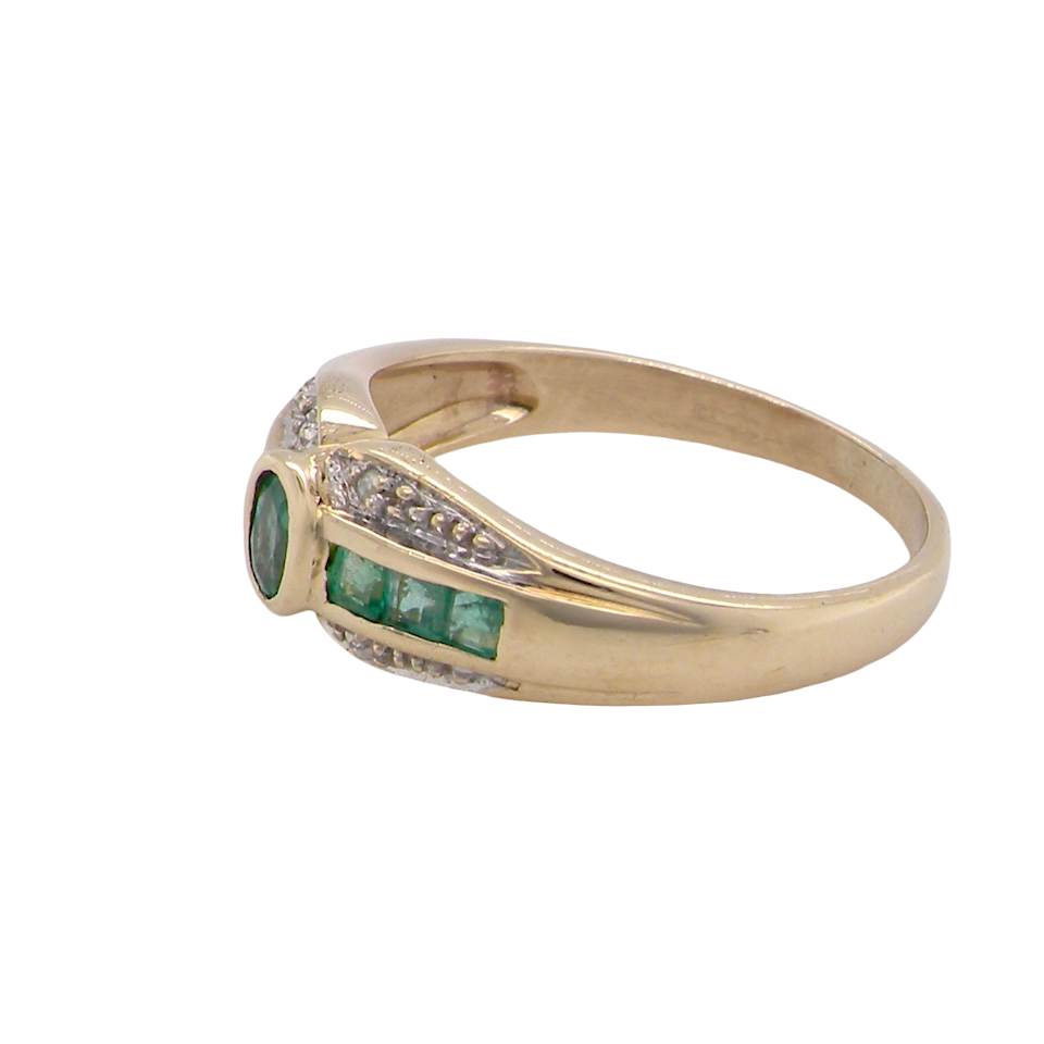 An emerald and diamond dress ring
