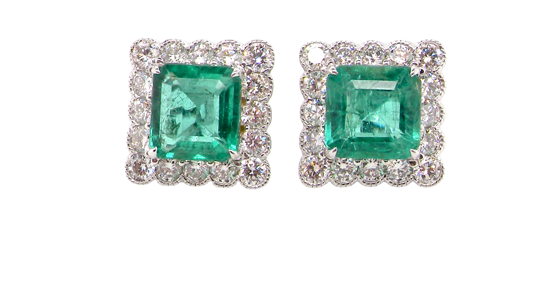 An exceptional pair of cluster earrings. Each of these beautiful earrings is set with a stunning square cut emerald, measures 7x7mm