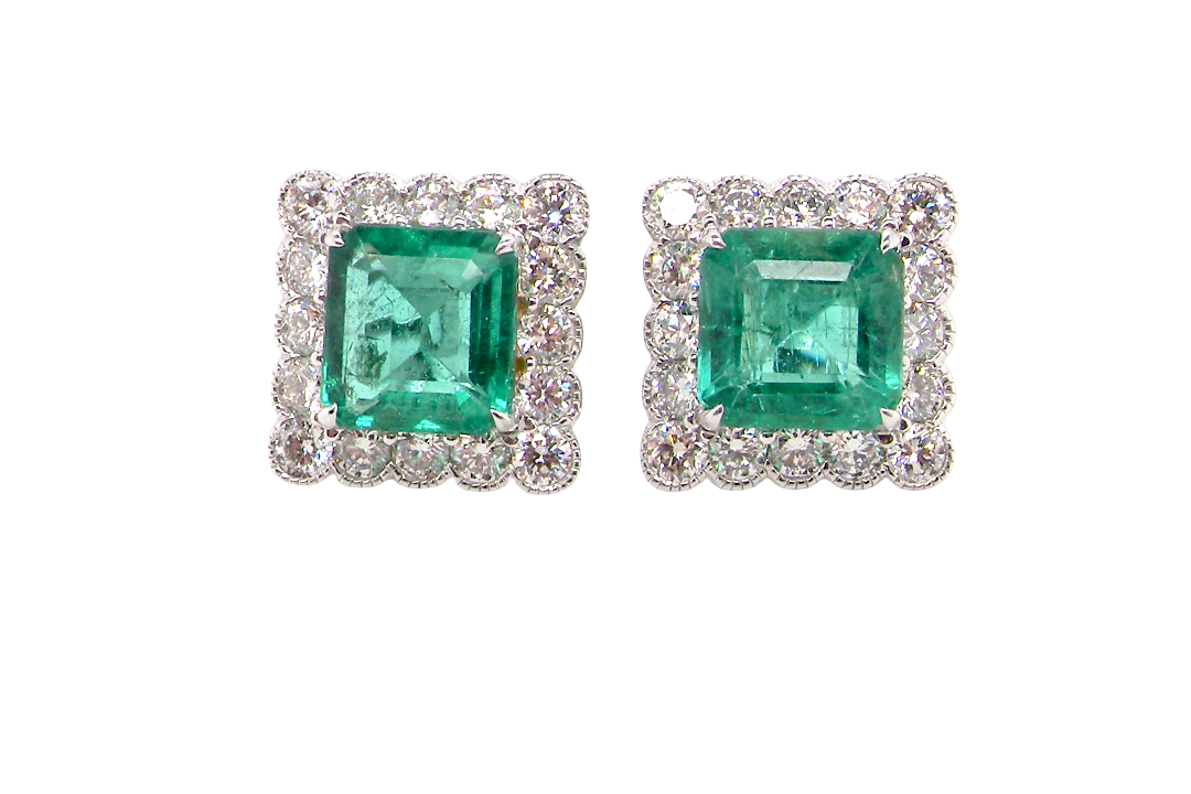 An exceptional pair of cluster earrings. Each of these beautiful earrings is set with a stunning square cut emerald, measures 7x7mm