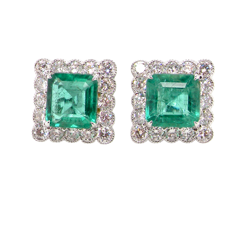 An exceptional pair of cluster earrings. Each of these beautiful earrings is set with a stunning square cut emerald, measures 7x7mm