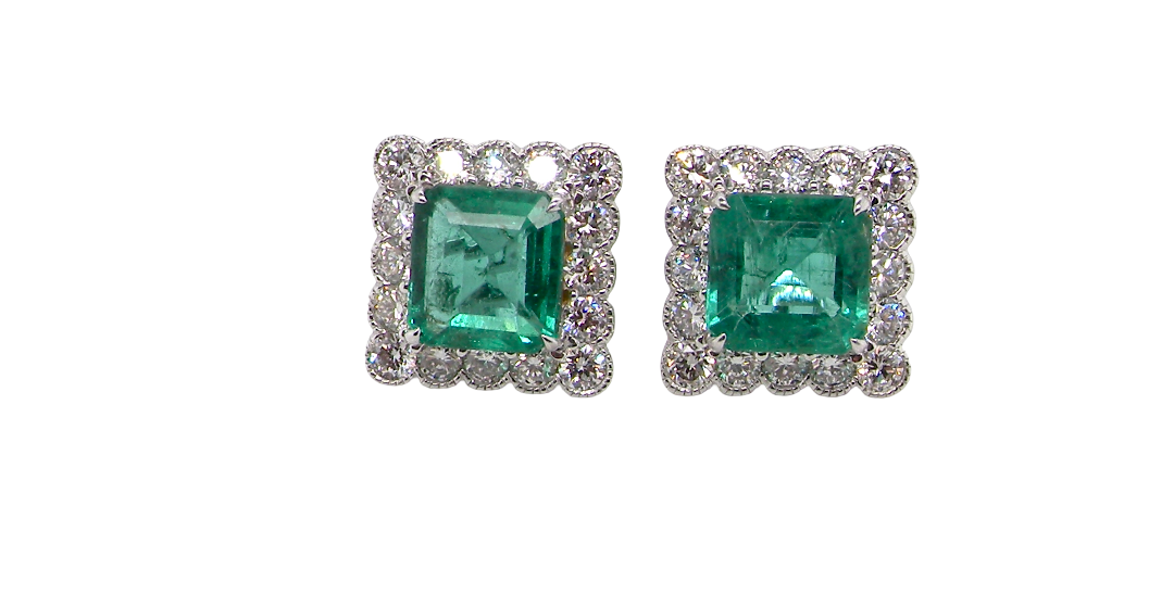 An exceptional pair of cluster earrings. Each of these beautiful earrings is set with a stunning square cut emerald, measures 7x7mm (est carat size 1.8 carats) excellent colour