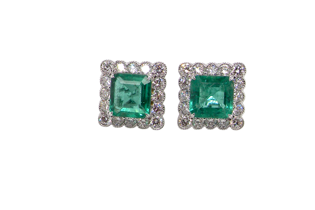 An exceptional pair of cluster earrings. Each of these beautiful earrings is set with a stunning square cut emerald, measures 7x7mm (est carat size 1.8 carats) excellent colour