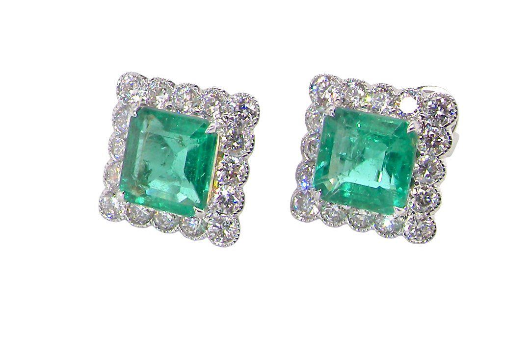 An exceptional pair of cluster earrings. Each of these beautiful earrings is set with a stunning square cut emerald, measures 7x7mm (est carat size 1.8 carats) excellent colour and clarity with