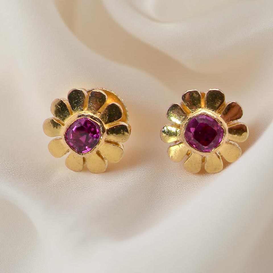 An exceptional pair of ruby earrings.Each earring is centred with a cushion-shaped ruby measuring 3.6–3.8mm,