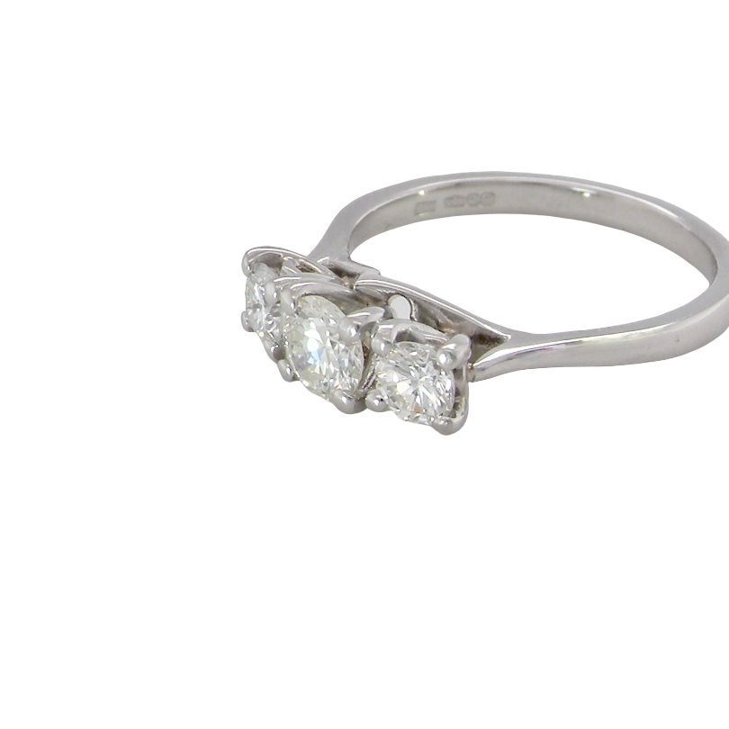An exceptional three stone diamond trilogy ring, beautifully crafted in platinum and set with three modern brilliant cut white diamonds. side