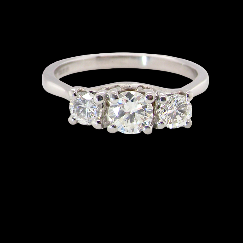 An exceptional three stone diamond trilogy ring, beautifully crafted in platinum and set with white diamonds.