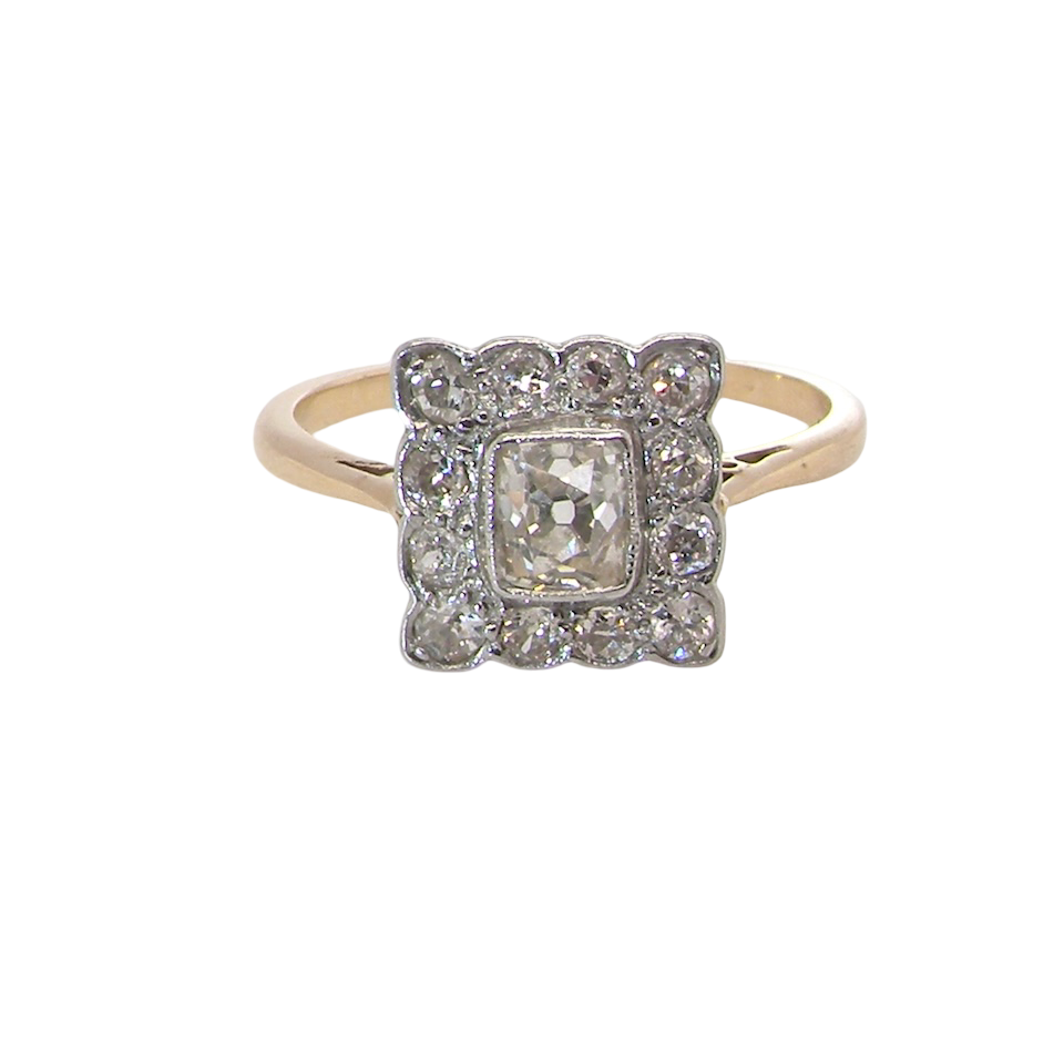 An exquisite Art Deco diamond cluster ring, beautifully handcrafted and rich in period charm.
At its centre sits a striking rectangular cut diamond measuring approximately 5 x 4.8mm, estimated at 0.50 carats,