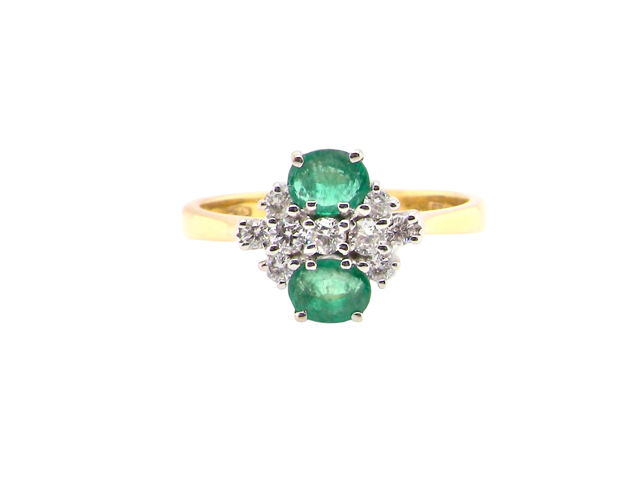 Gold ring with emeralds and diamonds on a white background