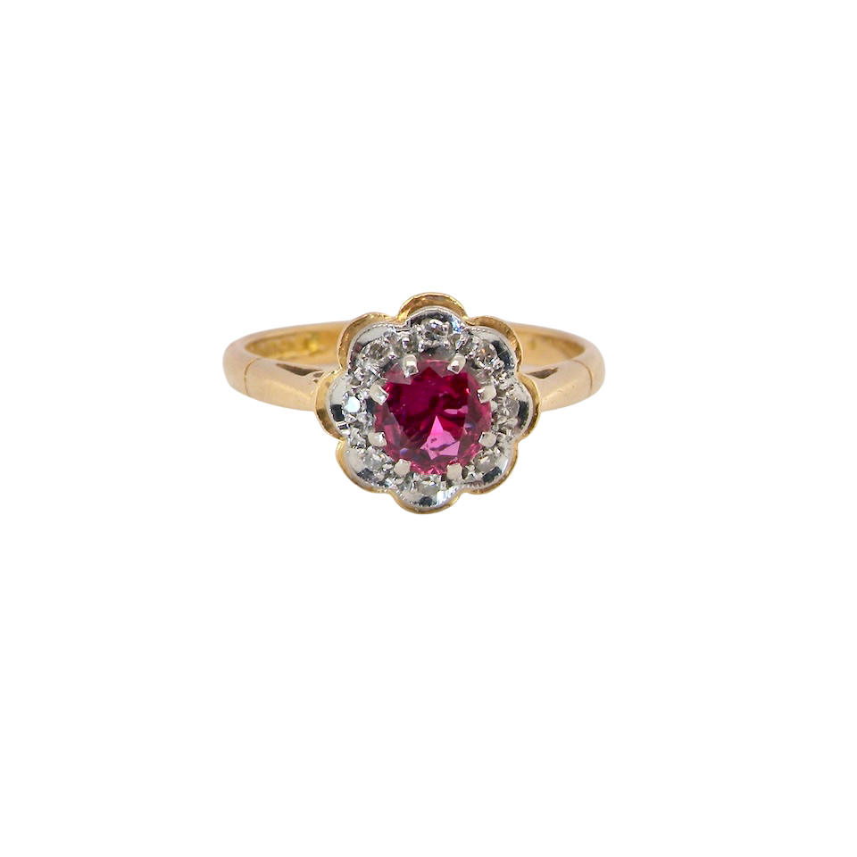 An exquisite vintage cluster ring centred around a 5 mm ruby,( 0.50 carats)