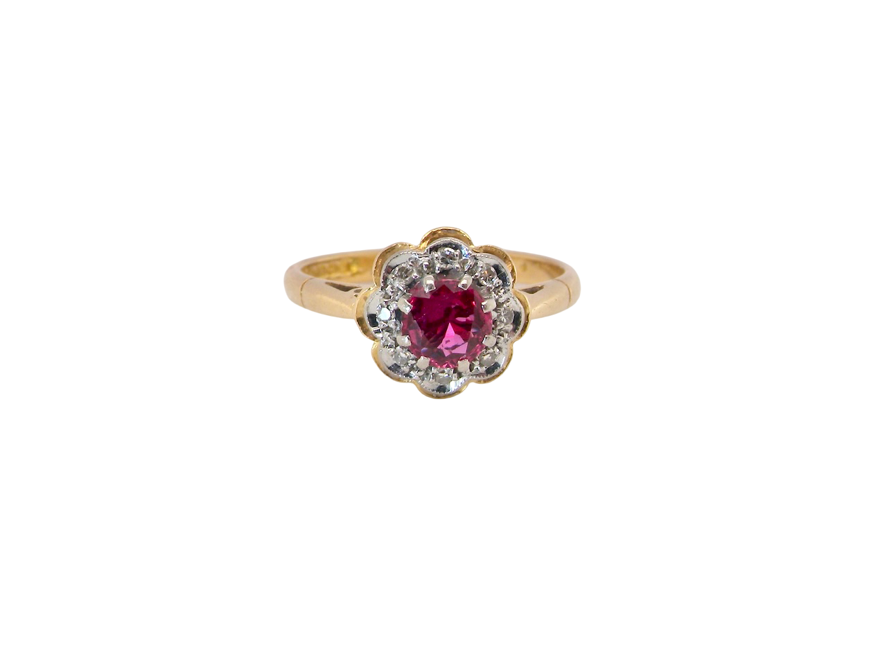 An exquisite vintage cluster ring centred around a 5 mm ruby,( 0.50 carats)