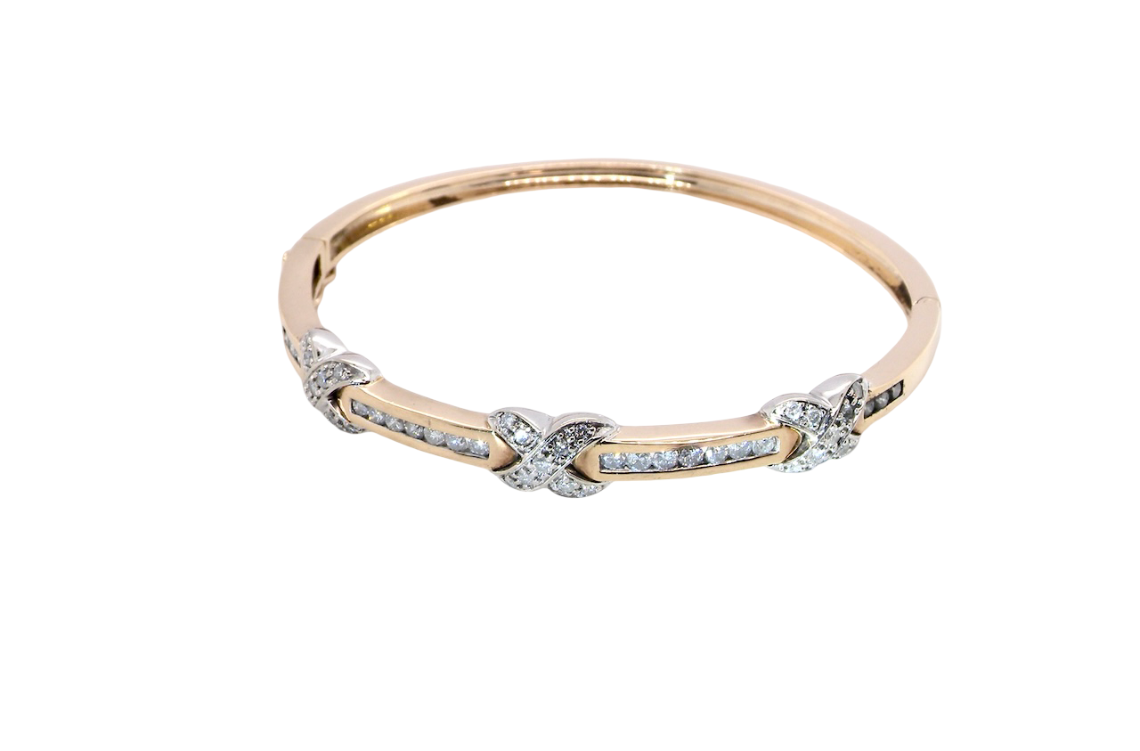 An impressive 9 carat gold bangle.
Three 'kiss' shaped sections , each set with nine brilliant cut white diamonds
