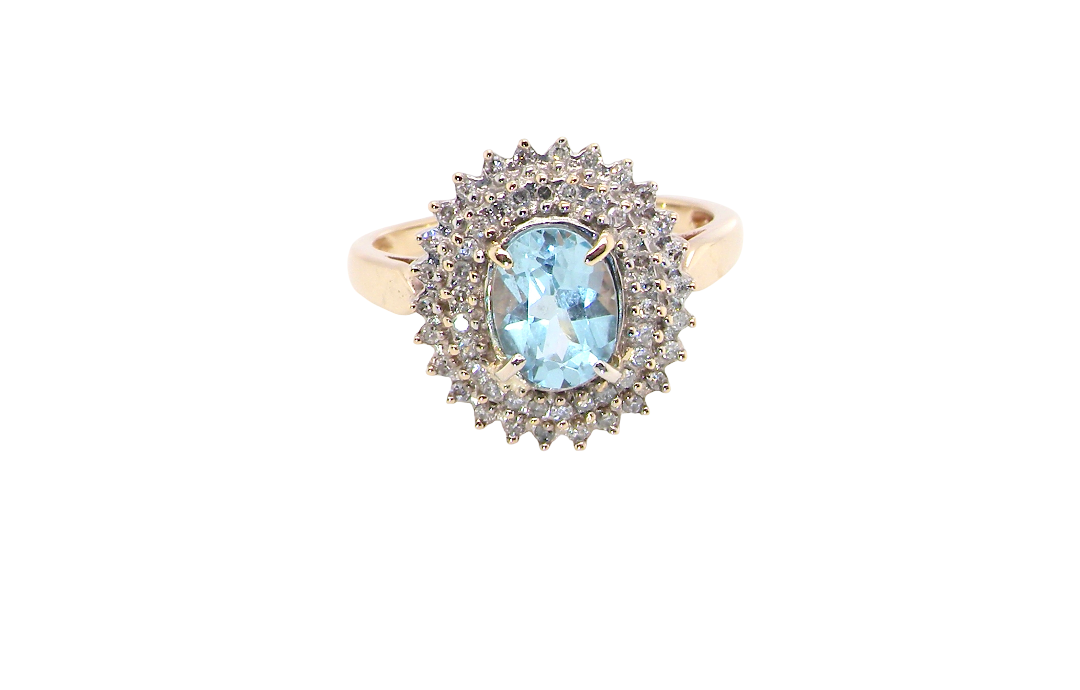 An impressive cluster ring that features to the centre an oval cut blue topaz gemstone, 8x6mm sky blue colour.
Complimented by an outer double halo of diamonds