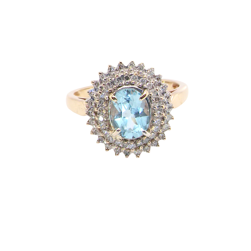 An impressive cluster ring that features to the centre an oval cut blue topaz gemstone, 8x6mm sky blue colour.
Complimented by an outer double halo of diamonds