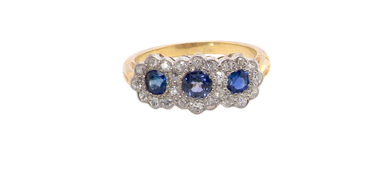 An impressive multi cluster ring. Set with three cornflower blue sapphires to each centre, 4.3mm, and each side a 3.3mm sapphire. Based on an Edwardian design