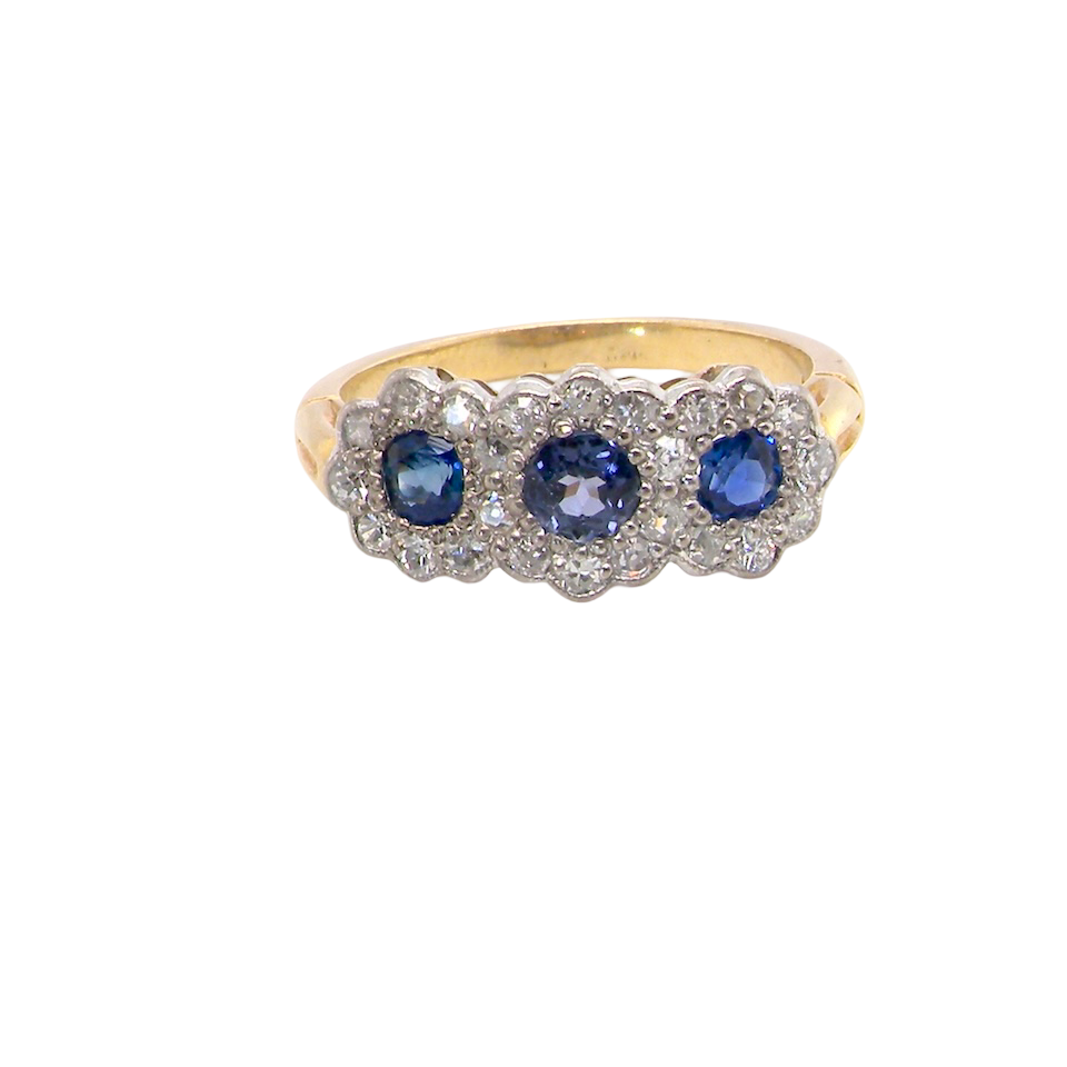An impressive multi cluster ring. Set with three cornflower blue sapphires to each centre, 4.3mm, and each side a 3.3mm sapphire. Based on an Edwardian design