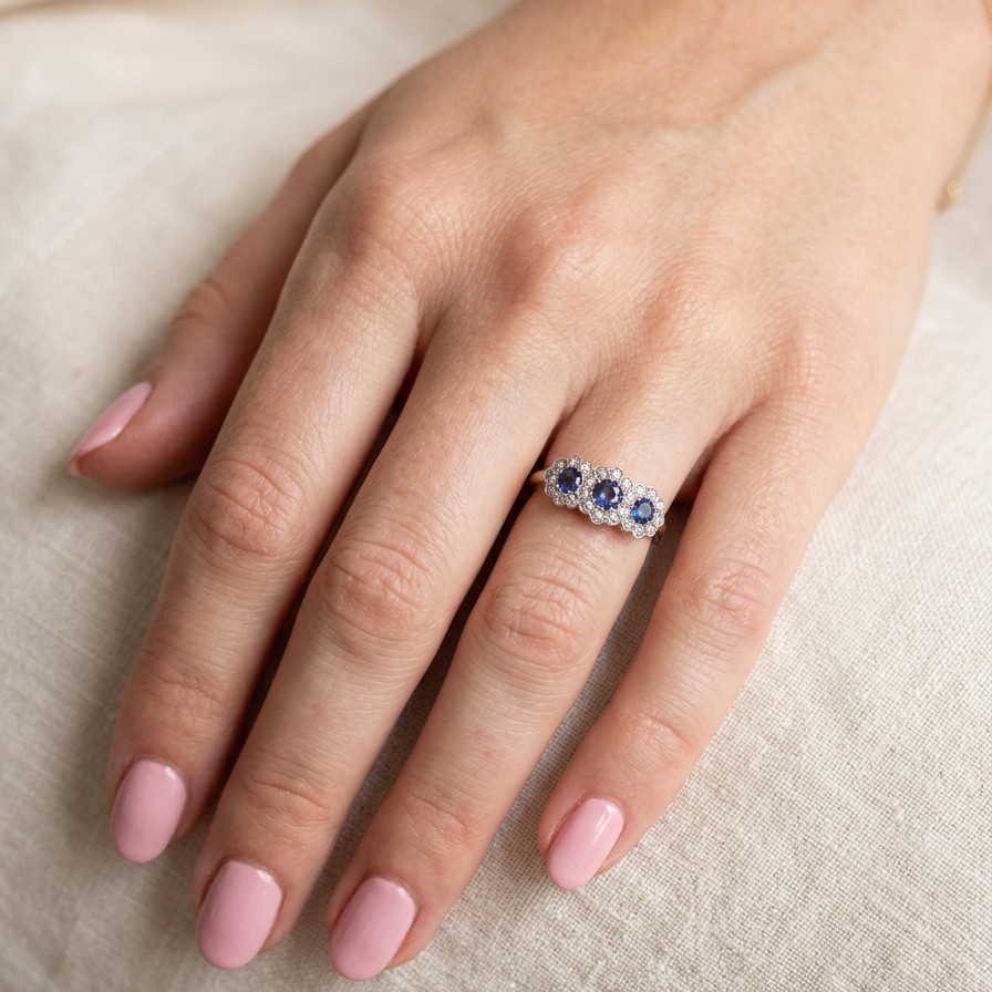 An impressive multi cluster ring. Set with three cornflower blue sapphires to each centre, 4.3mm, and each side a 3.3mm sapphire. Based on an Edwardian design
hand