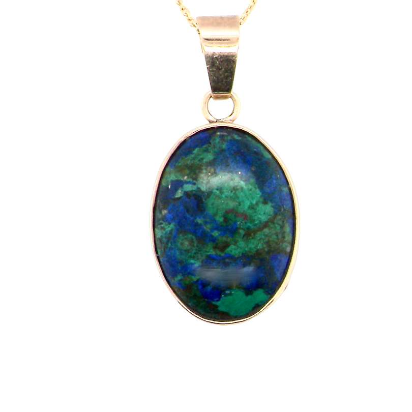 An interesting pendant set with an azurmalachite semi precious gem stone. Measures 20x15mm. Gold rim edged setting, with a V shaped bale.