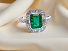 An  Emerald and Diamond Cluster Ring – 18 carat White Gold