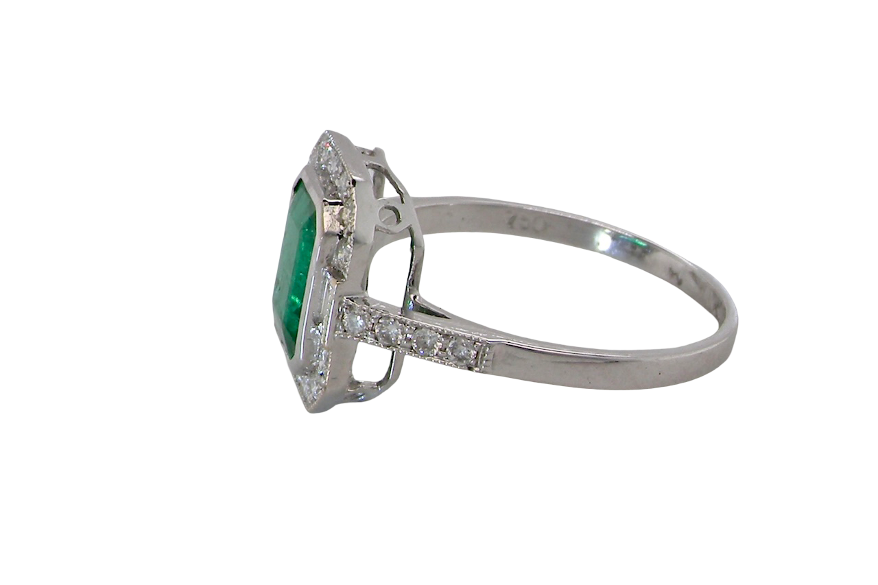 An 18ct white gold Emerald and Diamond Cluster Ring