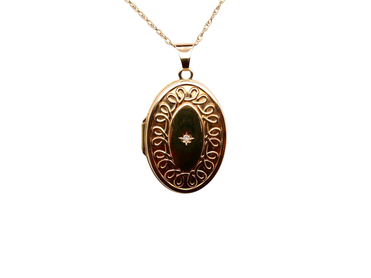 Gold locket with decorative design on a white background