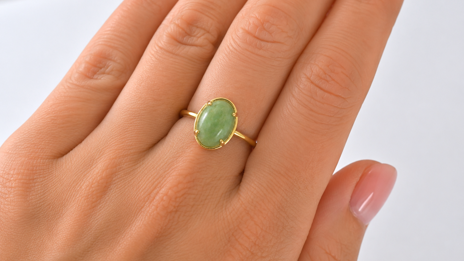 An oval jade nephrite ring on hand