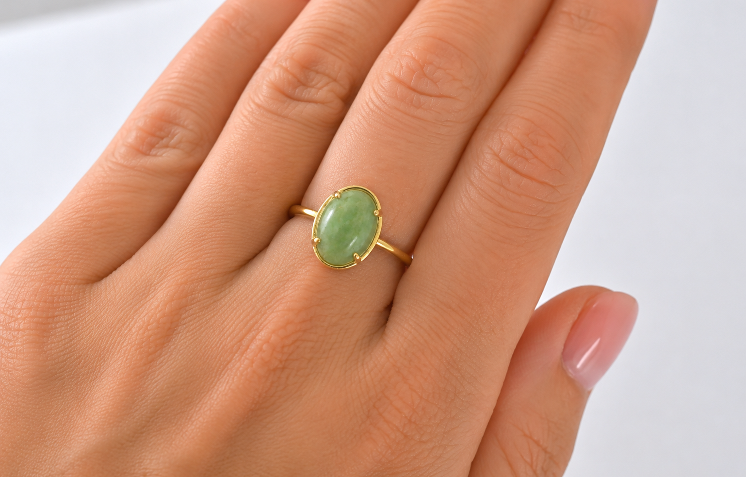 An oval jade nephrite ring on hand