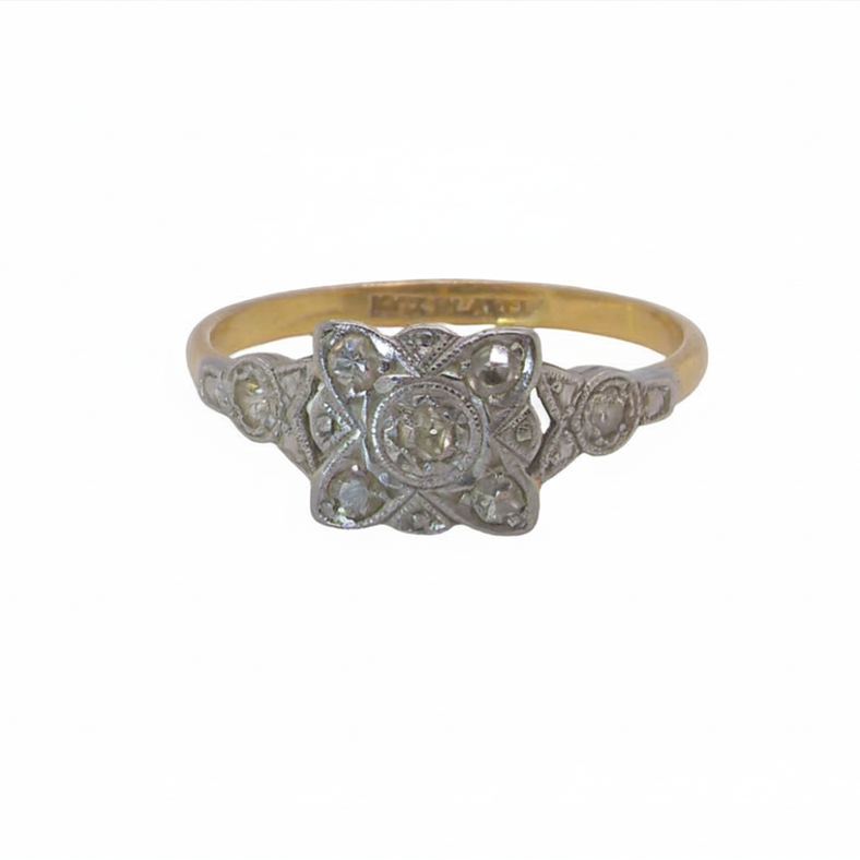 A pretty diamond cluster ring from the early part of the 20th century. A square head that has within it small white diamonds, measures 8x8mm, fancy shoulders also set with tiny diamonds.