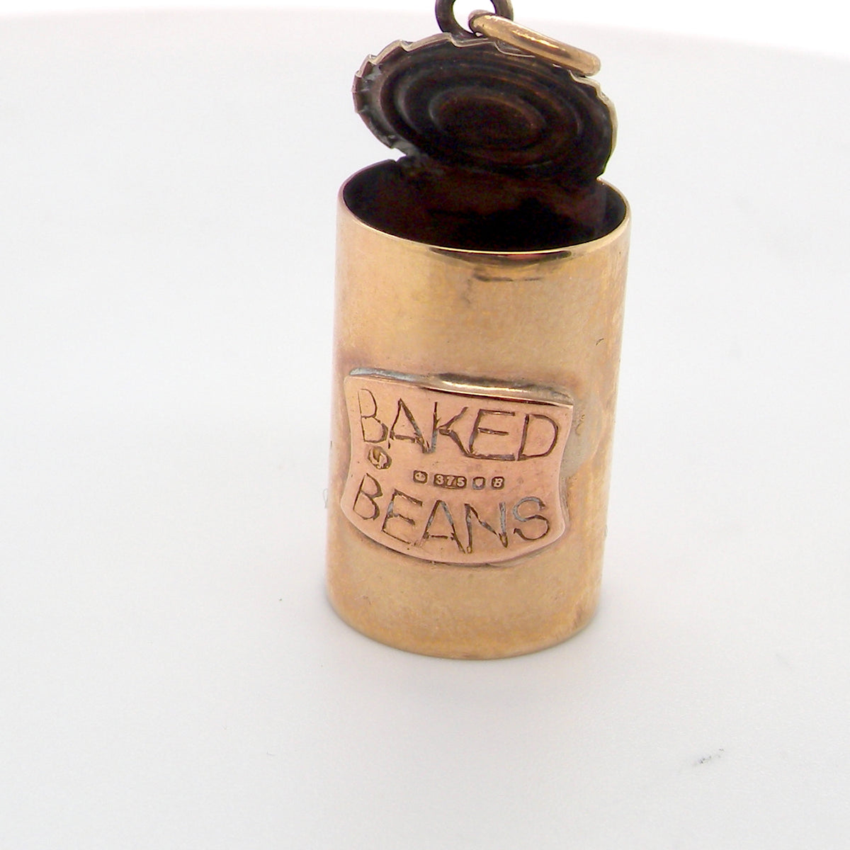 An unusual 9 carat gold charm . Shaped as a baked bean can,