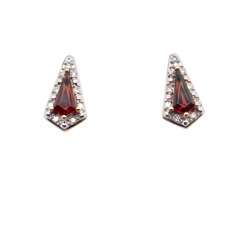 An unusual shaped pair of earrings. To the centre a kite shaped garnet