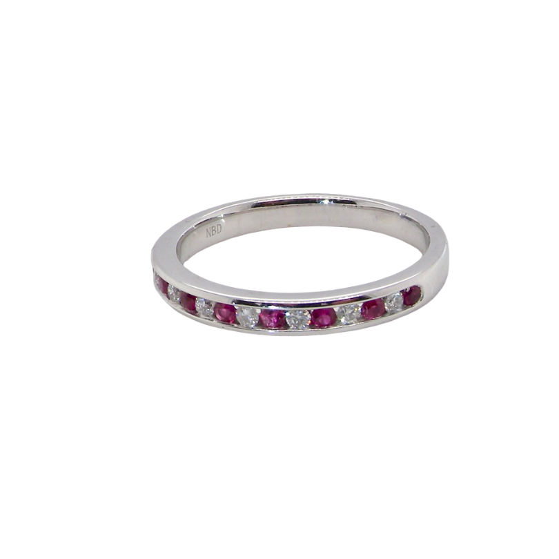 A white gold half hoop eternity ring. Set with seven round rubies and six brilliant cut white diamonds