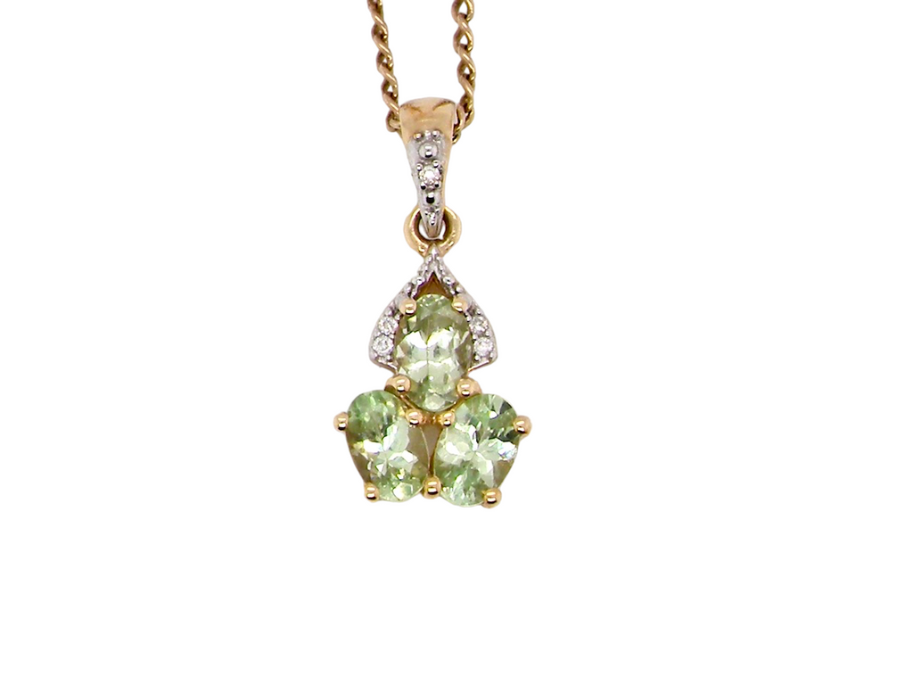  A gold peridot and diamond pendant