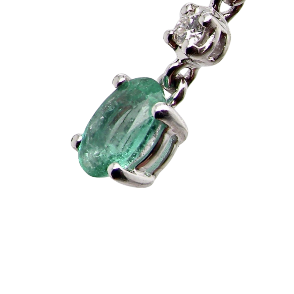 An emerald and diamond earring