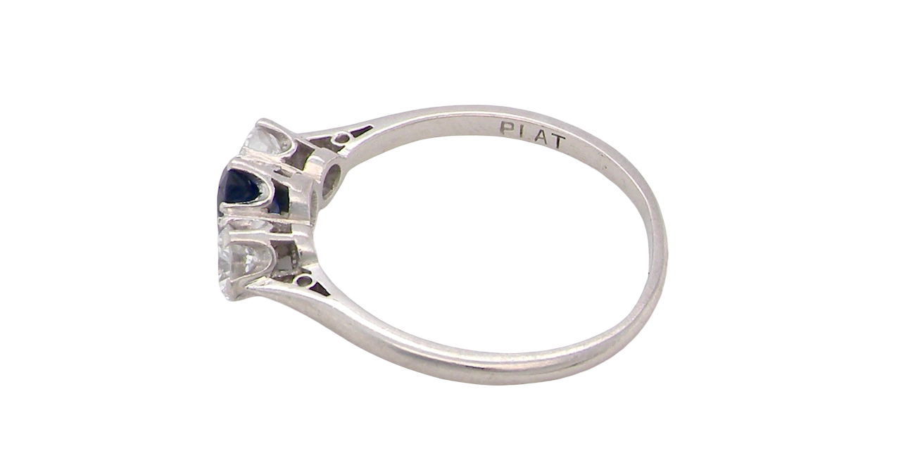 side classic trilogy ring set with an exquisite oval cut sapphire centre stone, hues of deep blue colour and measuring 6x4.2mm (est approx 0.50 carats)