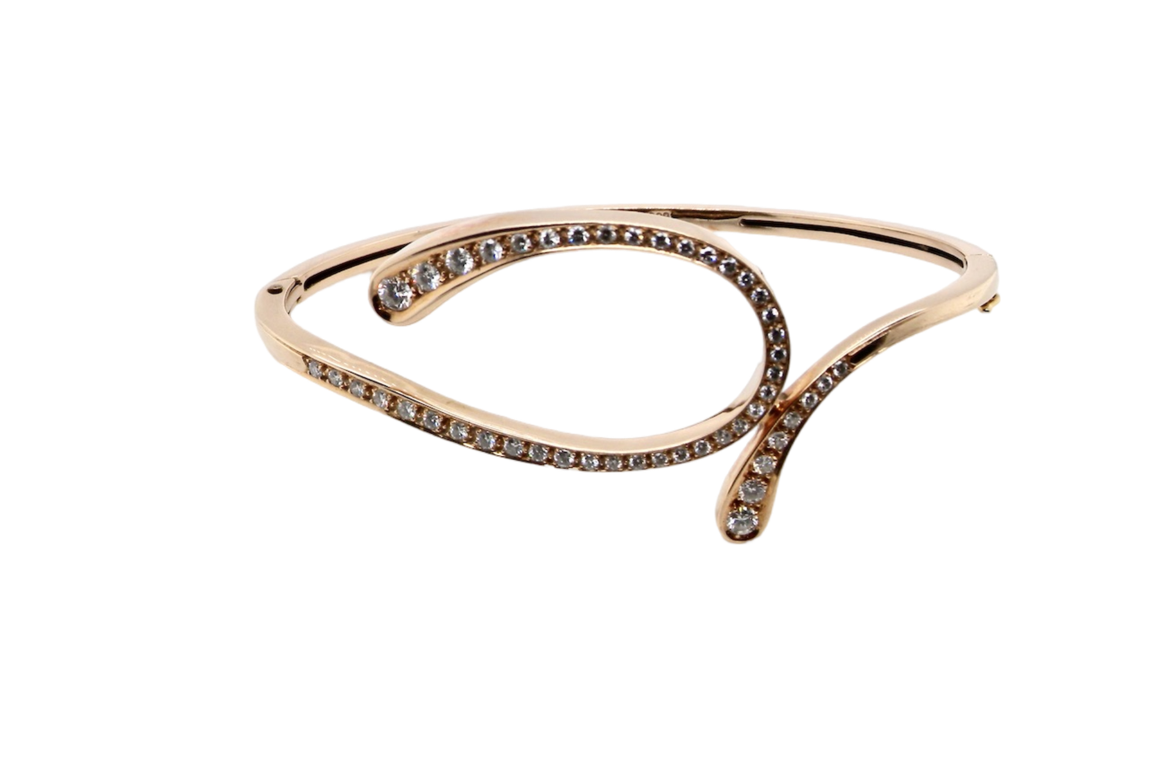 A 14 carat gold diamond loop bangle