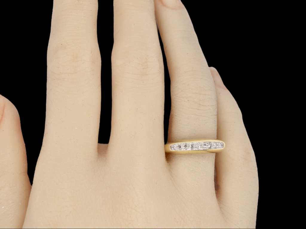 An 18 carat gold diamond half hoop eternity ring